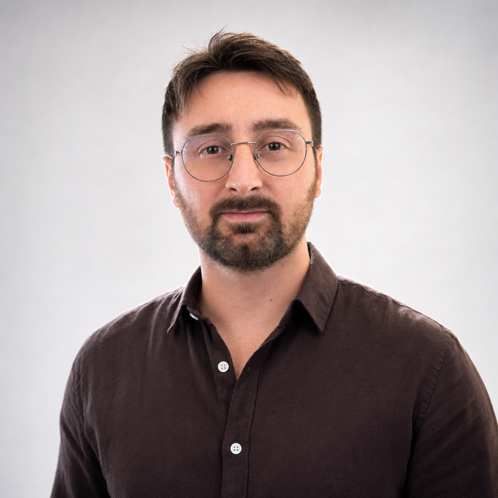 Bright frontal corporate headshot of the author with clamshell beauty lighting, generated with GPT Image 2